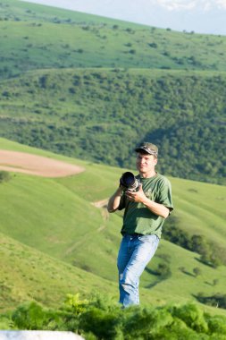 Shymkent, Kazakhstan - 04 May 2017: The guy with the camera, shoots the landscape.