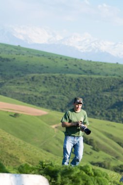 Shymkent, Kazakhstan - 04 May 2017: The guy with the camera, shoots the landscape.