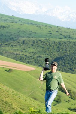 Shymkent, Kazakhstan - 04 May 2017: The guy with the camera, shoots the landscape.