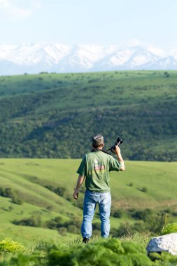 Shymkent, Kazakhstan - 04 May 2017: The guy with the camera, shoots the landscape.