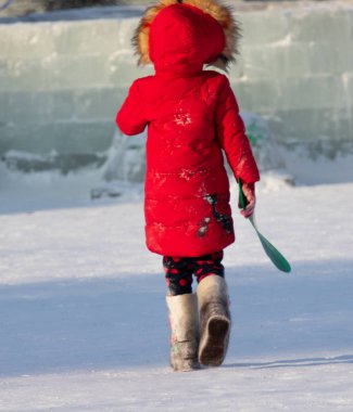 Petropavlovsk, Kazakistan - 8 Ocak 2019: Çocuk buzlu bir tepede binmek. Yetişkinler ve çocuklar parkta birlikte sakin ol.