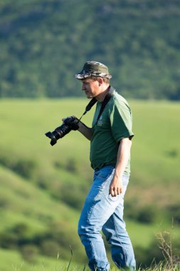Shymkent, Kazakhstan - 04 May 2017: The guy with the camera, shoots the landscape.