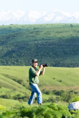 Shymkent, Kazakhstan - 04 May 2017: The guy with the camera, shoots the landscape.