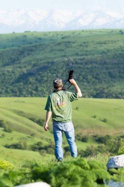 Shymkent, Kazakhstan - 04 May 2017: The guy with the camera, shoots the landscape.