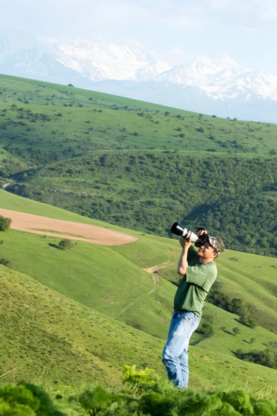 Shymkent, Kazakhstan - 04 May 2017: The guy with the camera, shoots the landscape.