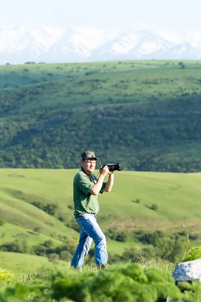 Shymkent, Kazakhstan - 04 May 2017: The guy with the camera, shoots the landscape.
