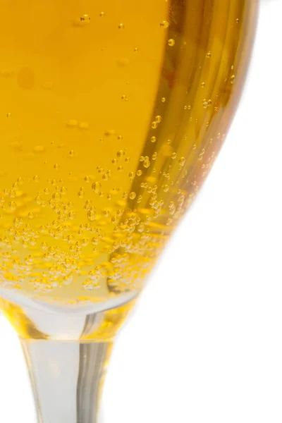 yellow drink with gas in a drink glass on a white background