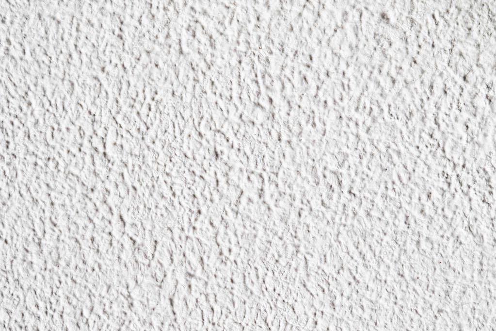 Background texture.White concrete wall. Small cracks on the surface.