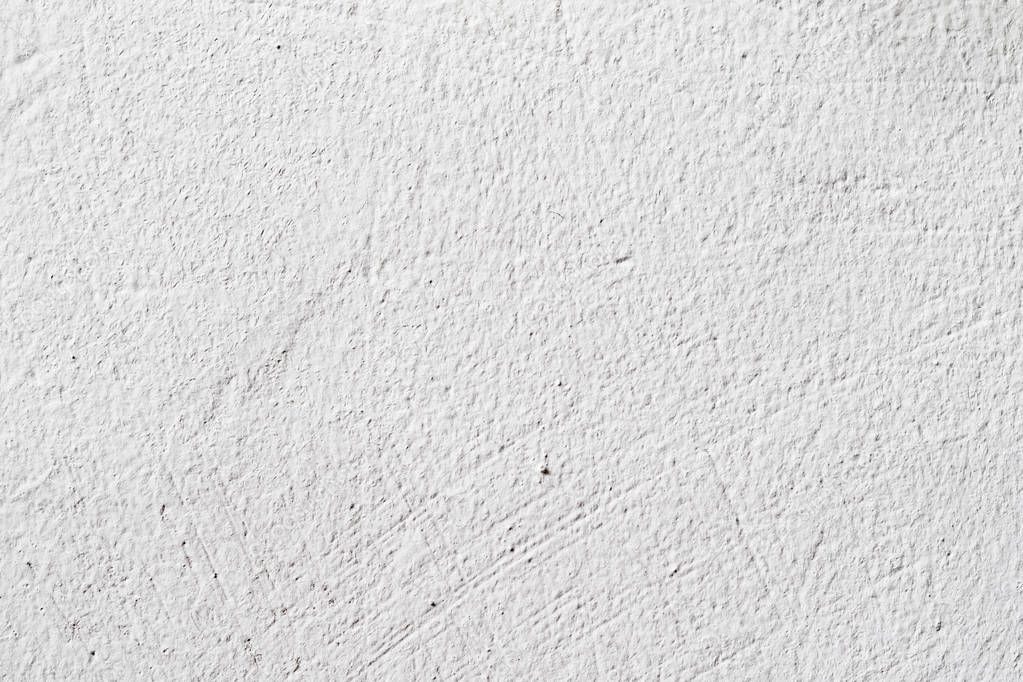 Background texture.White concrete wall. Small cracks on the surface.