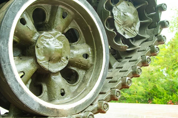 Caterpillars of a tank wheel close up.