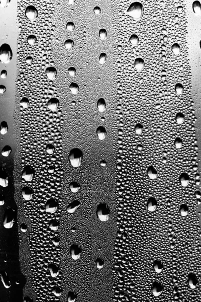 Raindrops on the glass, black-white background, fashion glass texture.