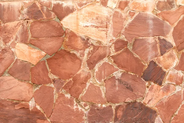 Arka plan olarak kırmızı granit taş duvar