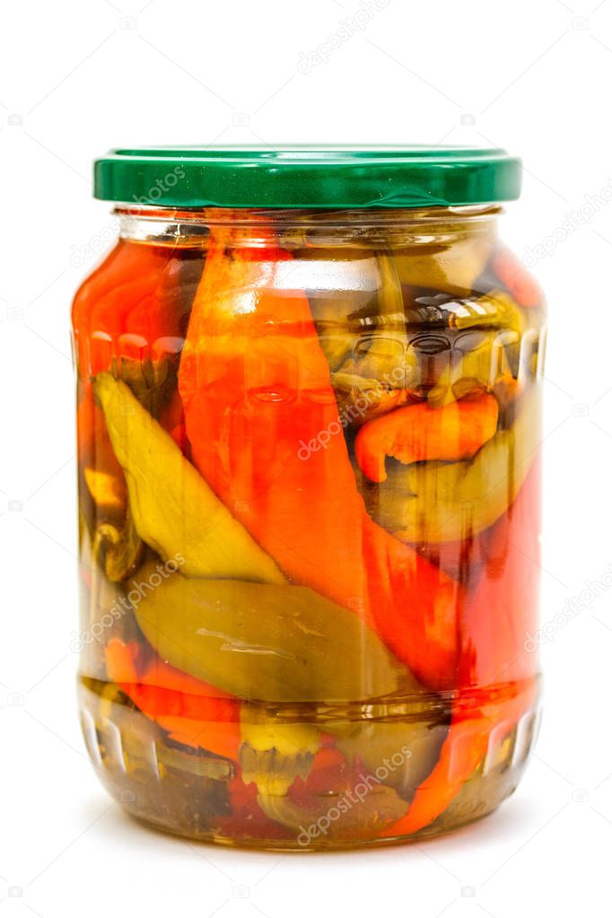 Glass jar with pickled peppers on a white background.
