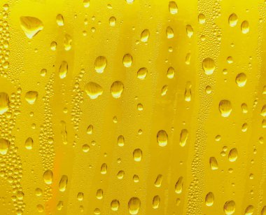 Cam su damlaları, sarı arka plan bira, buğulu arka plan.