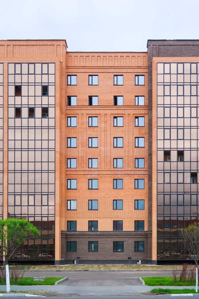 High-rise red brick house with windows, architecture.