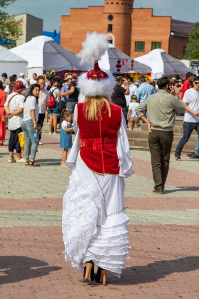 Petropavlovsk, Kazakistan - 17 Ağustos 2019: Çocukların aileleri şehrin sokaklarında ulusal kostümler içinde yürüyor. Gün tatili, binicilik sütü tatili, içki.