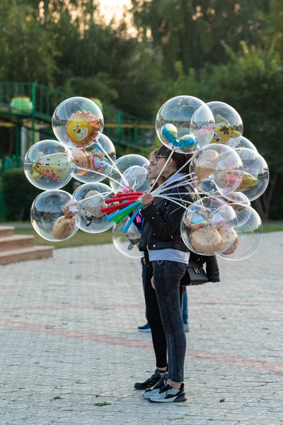 Petropavlovsk, Kazakistan - 23 Ağustos 2019: Anne babalar gece leri şehir parkında yürüyor. Gençler toplu şenlikler geçiriyor.
