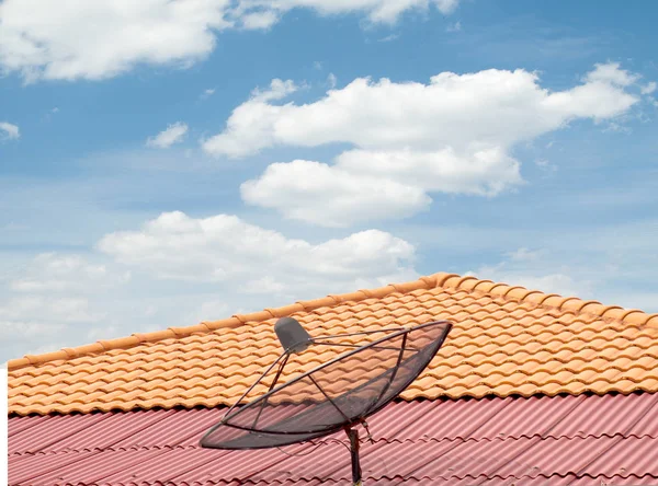 antenna on the roof of the house, the sky clouds