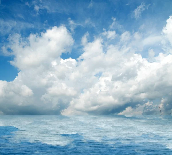 Sea clouds reflected in water