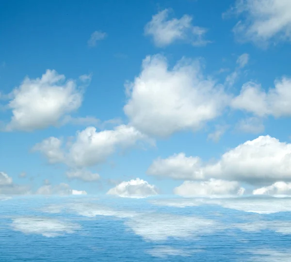 Sea clouds reflected in water