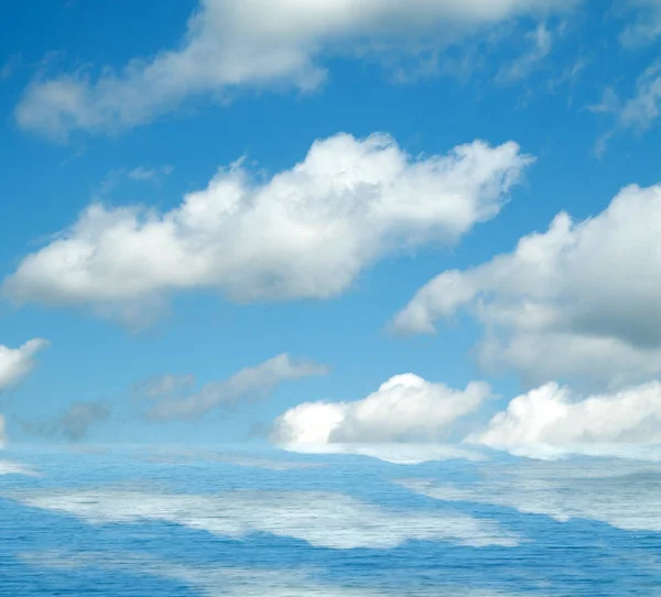 Sea clouds reflected in water