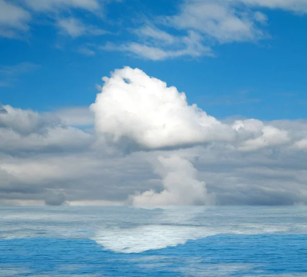 Sea clouds reflected in water