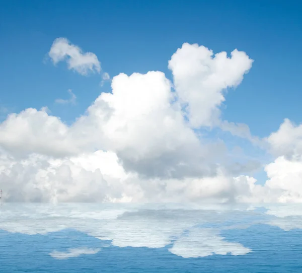 Sea clouds reflected in water