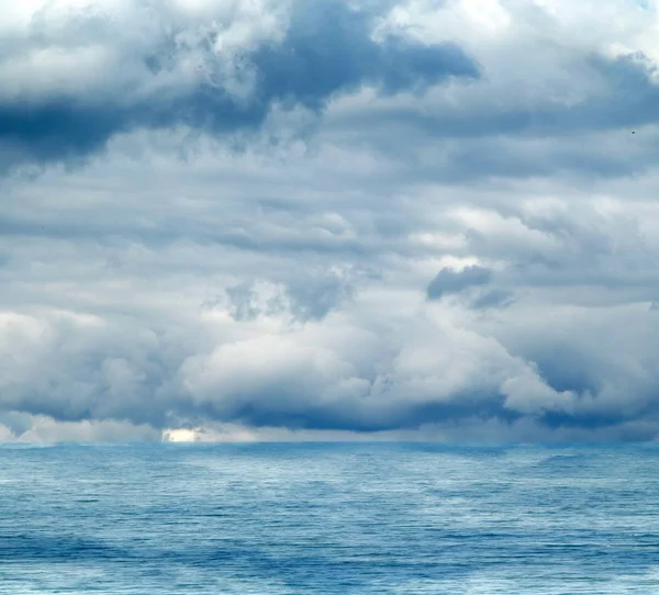 Sea clouds reflected in water