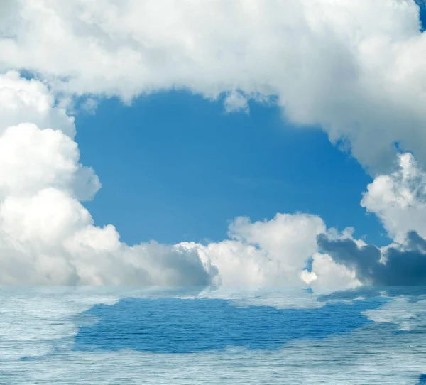 Sea clouds reflected in water