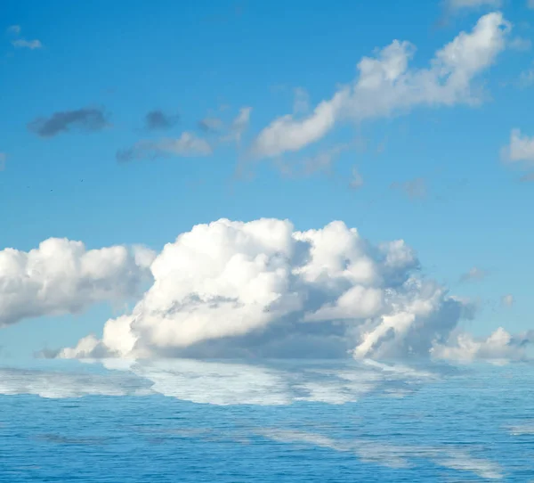 Sea clouds reflected in water