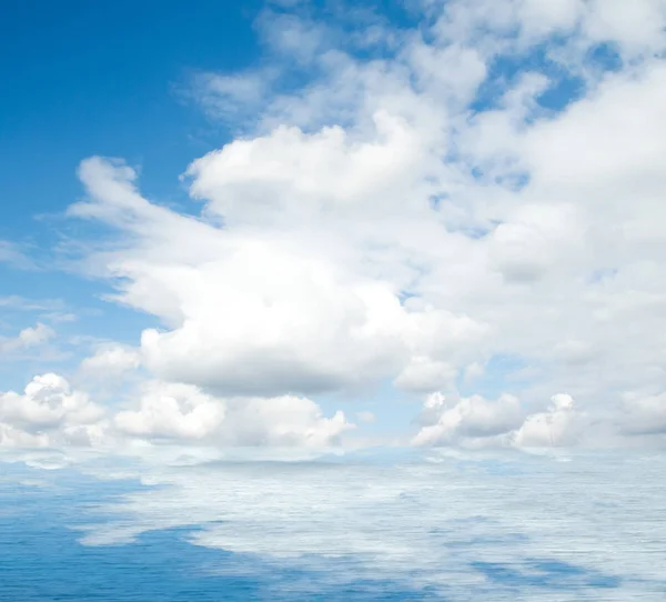 Sea clouds reflected in water