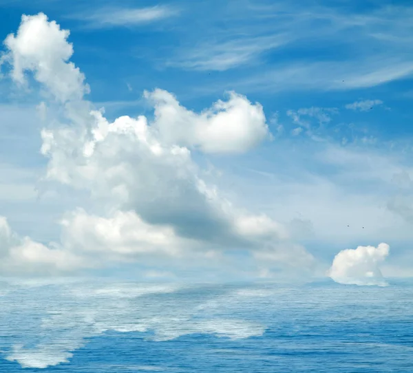 Sea clouds reflected in water