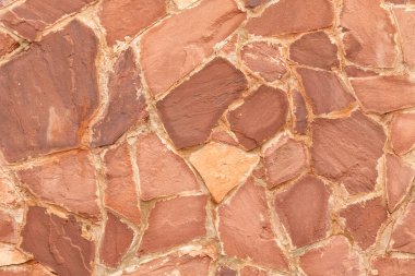 Arka plan olarak kırmızı granit taş duvar