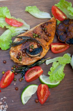 Ahşap kovuk ahşap güvertede tavuk göğsü pişirdi baharatlar ve sebzelerle.