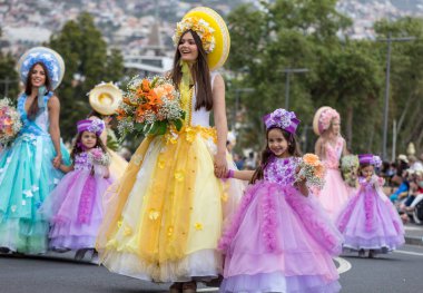 Funchal; Madeira; Portekiz - 22 Nisan; 2018: bir grup insan renkli kostümleri dans Madeira çiçek Festivali geçit töreninde Funchal, Madeira Adası üzerinde. Portekiz.