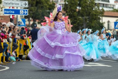 Funchal; Madeira; Portekiz - 22 Nisan; 2018: bir grup kadın renkli kostümleri dans Madeira çiçek Festivali geçit töreninde Funchal, Madeira Adası üzerinde. Portekiz.