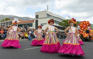 Funchal; Madeira; Portekiz - 22 Nisan; 2018: bir grup kadın renkli kostümleri dans Madeira çiçek Festivali geçit töreninde Funchal, Madeira Adası üzerinde. Portekiz.
