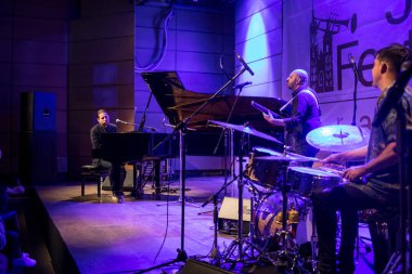 Cracow, Poland - June 27, 2018: Alfredo Rodriguez Trio live on stage in Manggha Museum of Japanese Art and Technology at the Summer Jazz Festival in Krakow, is the 23rd edition of the festival, which will host over 150 concerts and will perform over  clipart