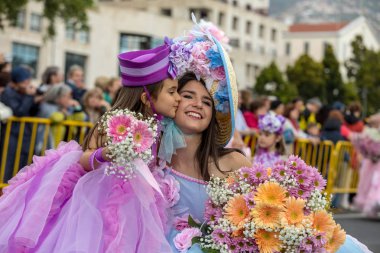 Funchal; Madeira; Portekiz - 22 Nisan; 2018: anne ve kızı Madeira çiçek Festivali geçit töreninde Funchal Madeira Adası, renkli kostümleri. Portekiz.