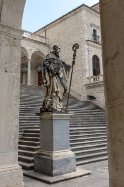 Montecassino, Italy - June 17, 2017: Marble statue of St. Benedict by P. Campi of Carrara, Cloister of Bramante, Benedictine abbey of Montecassino, Monte Cassino clipart