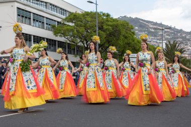 Funchal; Madeira; Portekiz - 22 Nisan; 2018: bir grup insan renkli kostümleri dans Madeira çiçek Festivali geçit töreninde Funchal, Madeira Adası üzerinde. Portekiz.