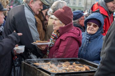 Krakov, Polonya - 16 Aralık 2018: Noel arifesi yoksul ve Cracow ana meydanında evsizlere için. Her yıl grup Kosciuszko Cracow açık havada büyük eve hazırlar. Polonya