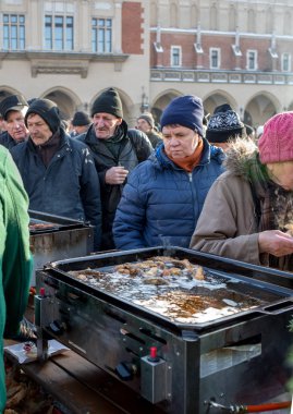 Krakov, Polonya - 16 Aralık 2018: Noel arifesi yoksul ve Cracow ana meydanında evsizlere için. Her yıl grup Kosciuszko Cracow açık havada büyük eve hazırlar. Polonya