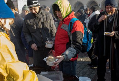 Krakov, Polonya - 16 Aralık 2018: Noel arifesi yoksul ve Cracow ana meydanında evsizlere için. Her yıl grup Kosciuszko Cracow açık havada büyük eve hazırlar. Polonya