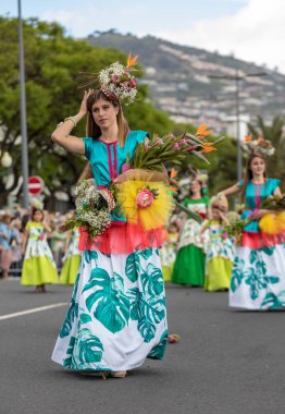 Funchal; Madeira; Portekiz - 22 Nisan; 2018: bir grup insan renkli kostümleri dans Madeira çiçek Festivali geçit töreninde Funchal, Madeira Adası üzerinde. Portekiz.
