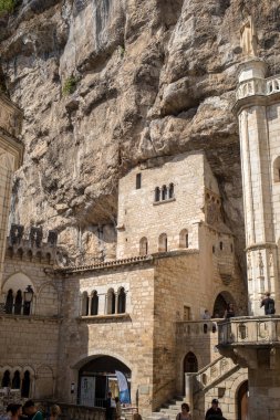Rocamadour, Fransa - 3 Eylül 2018: Tarihi St.-Sauveur Bazilikası taş duvarları Fransa 'nın Rocamadour kentindeki kayalıklara harmanlandı 