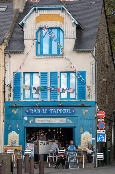 Cancale, France - September 15, 2018: Bars and restaurants on the main street in Canacle known for its delicious fish and seafood. Brittany, France