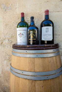 Saint Emilion, Fransa - 8 Eylül 2018: Fransa'nın Saint Emilion şehrinde bir şarap dükkanının önünde şarap şişeleri ile reklam yapısı. St Emilion Bordeaux ve çok popüler turistik başlıca kırmızı şarap alanlarından biridir.