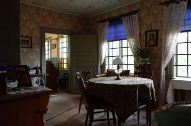 Vasteras, Sweden - 7 September, 2018: Living room interior where the teacher lived in Village school in Vallby open air museum - the recreated 19th-century village demonstrating Swedish culture clipart