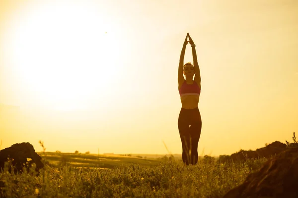 Vrouw doet stretching buiten. Warming-up oefening tegen zonsondergang. Sport en gezond actief Lifesyle concept. — Stockfoto